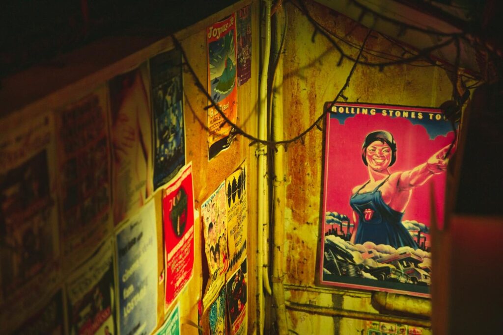 An atmospheric scene with vintage posters in a dimly lit underground location in Osaka, Japan.